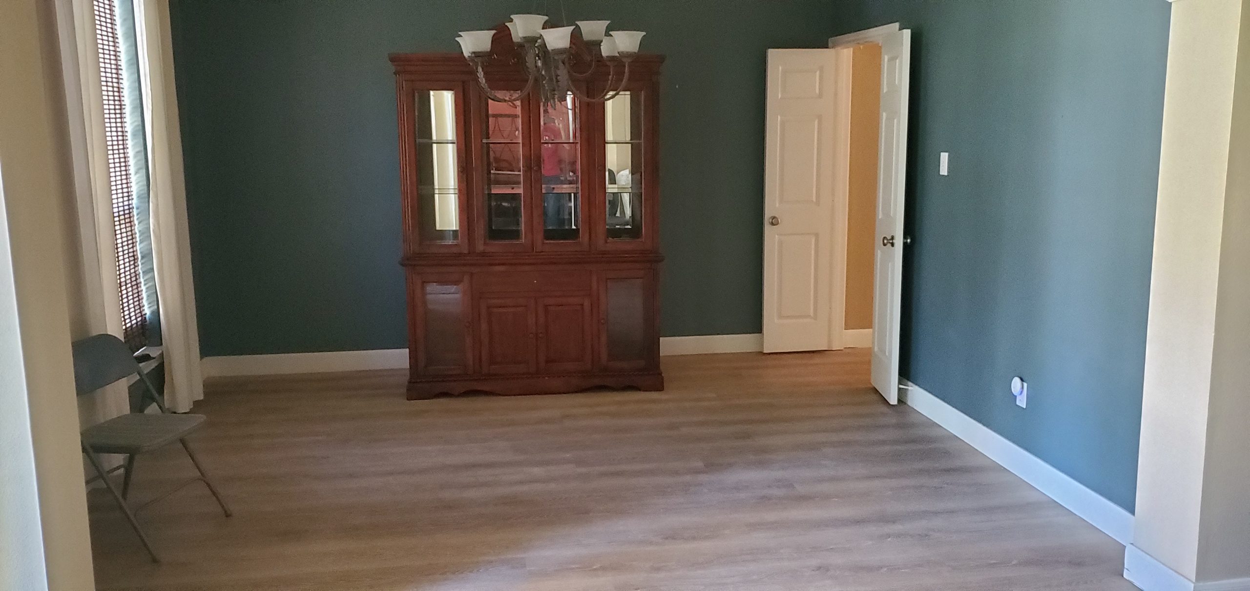 a newly renovated living room with a cabinet