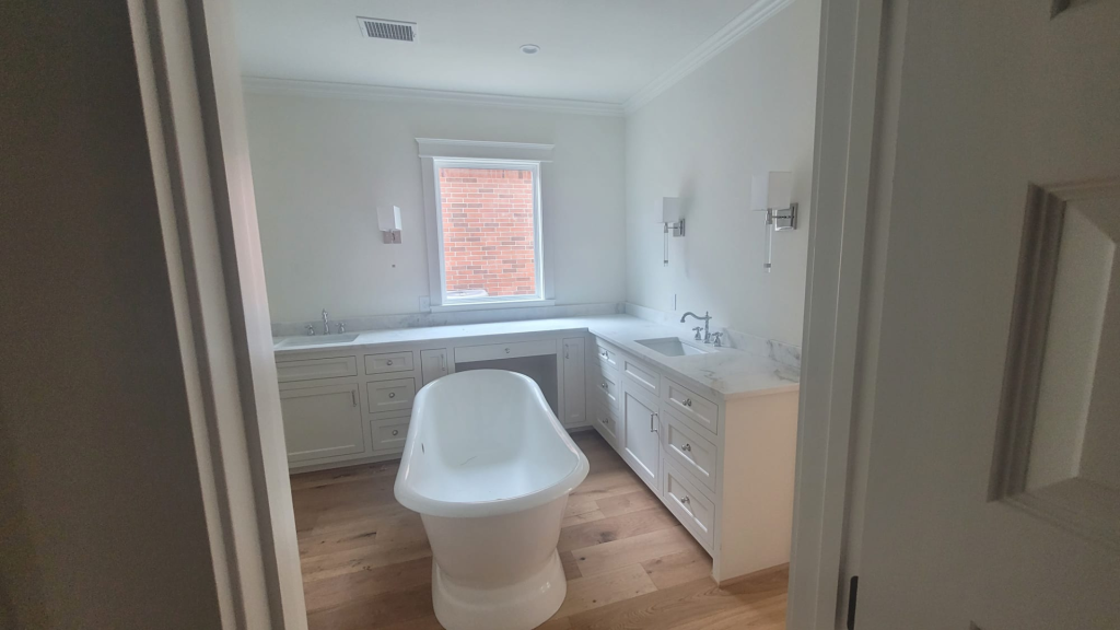 A bathroom with a white tub and a modern sink.